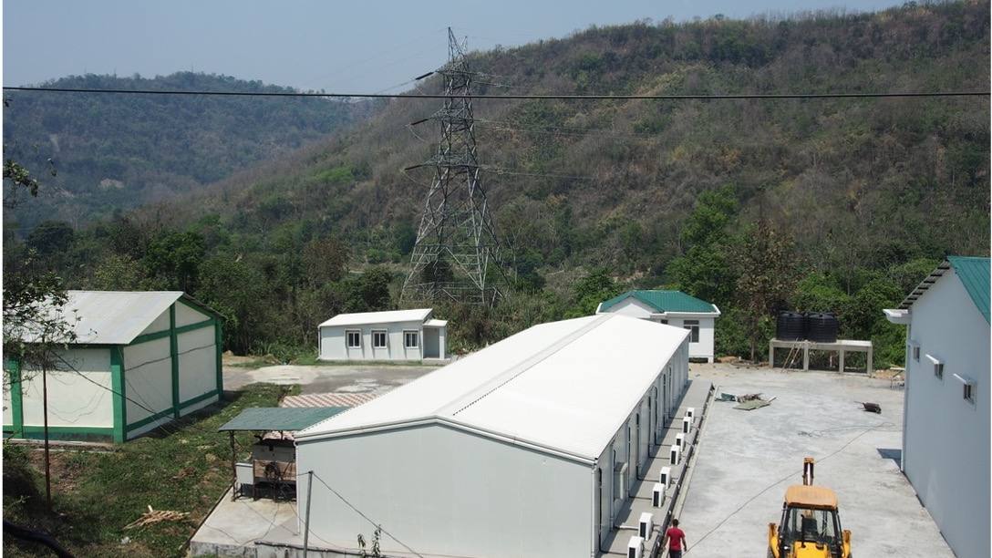 Agricultural storage and processing buildings set in forested hills